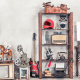 A collection of antique items such as a gramaphone, teddy bear and an old guitar.