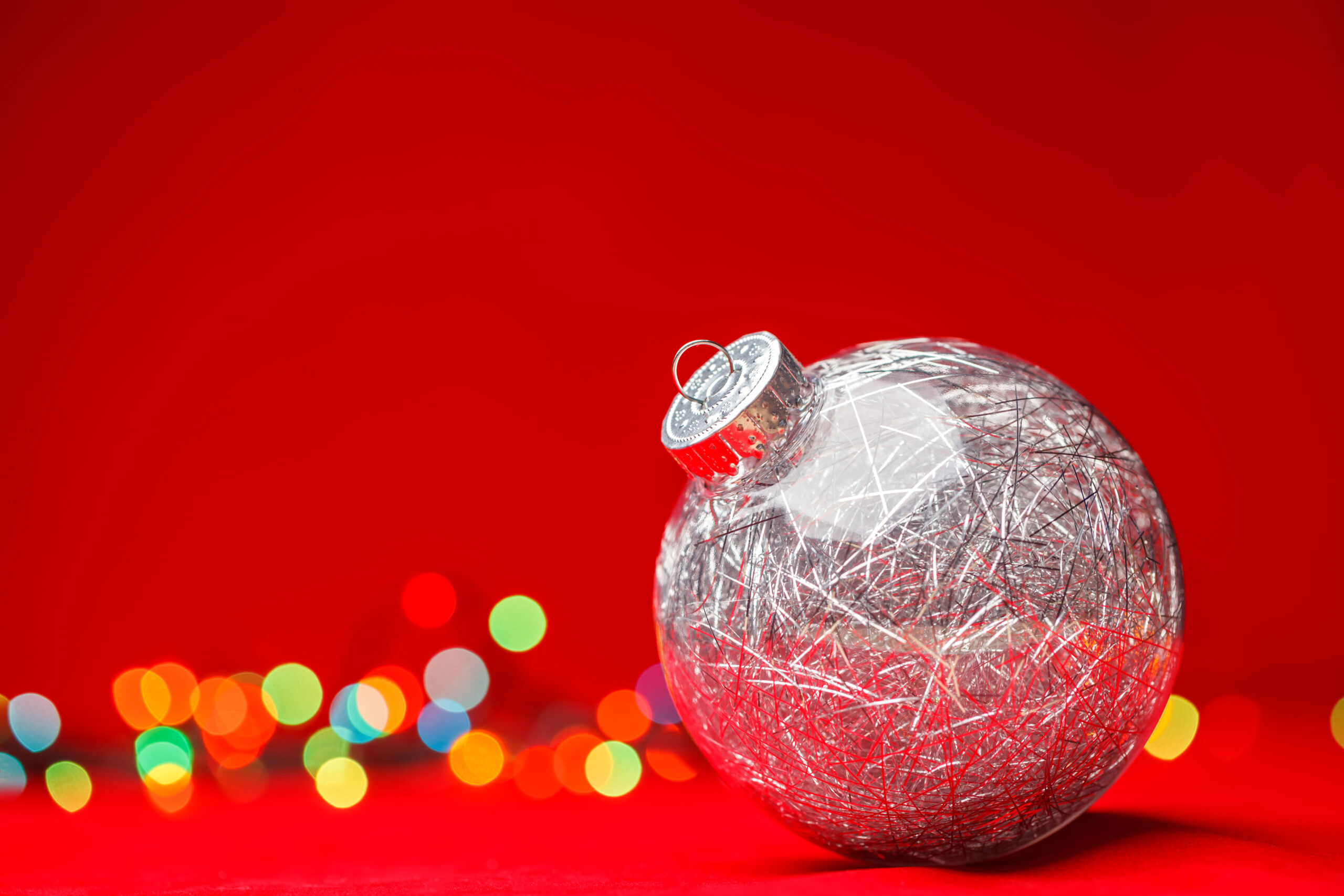 Silver bauble with red background