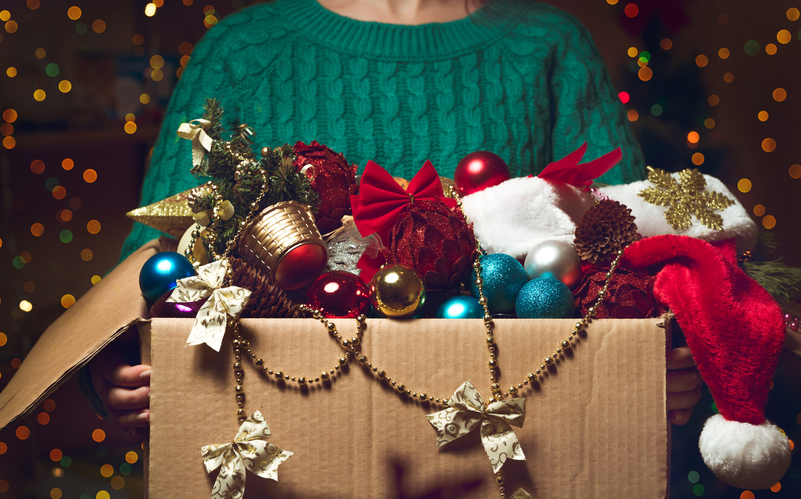 Woman-Holds-A-Box-With-Christmas-Decorations-For-Storage