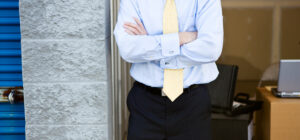 A man in a suit starting up a small business from a storage unit.