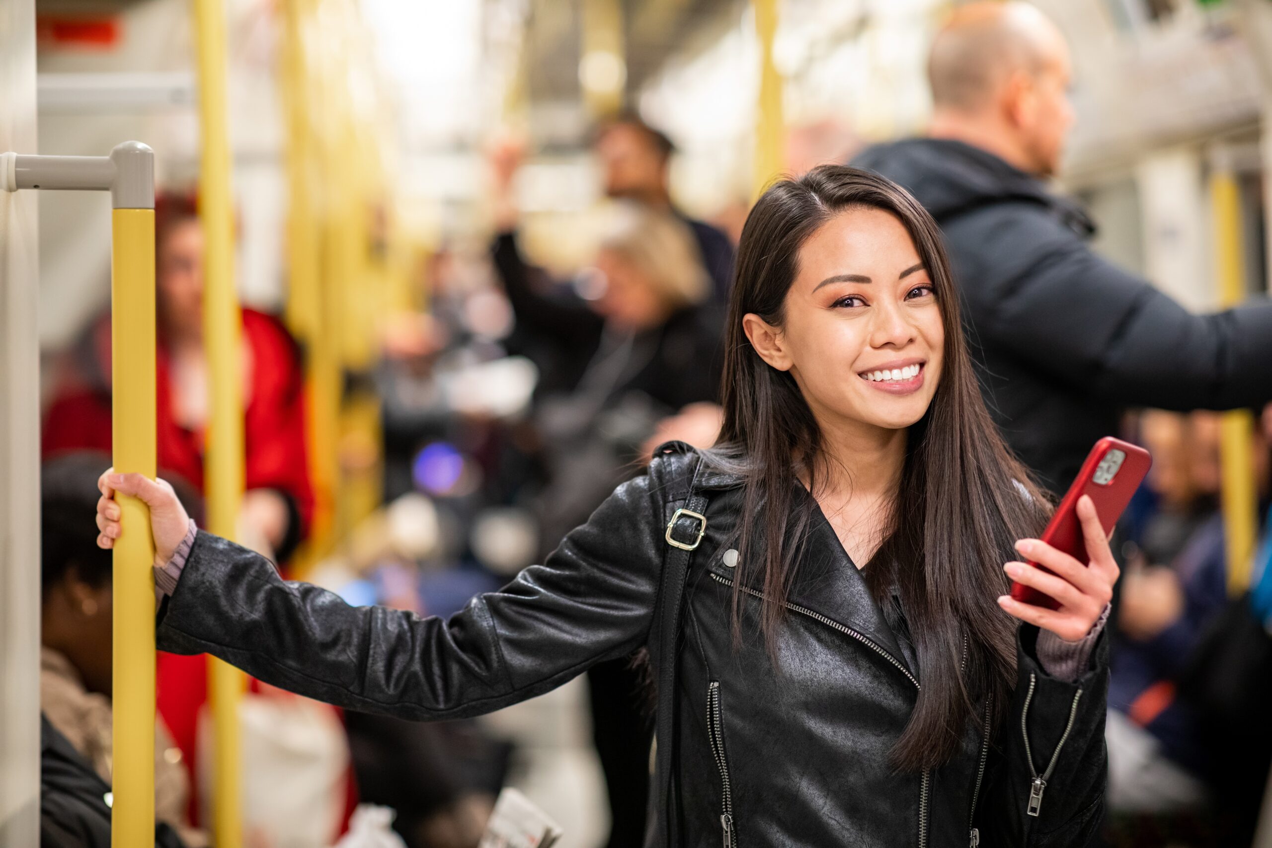 An image of a young woman standing on the London Tube in Acton.