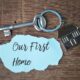 An image of a first home keyring with a house pendant on it on a table.