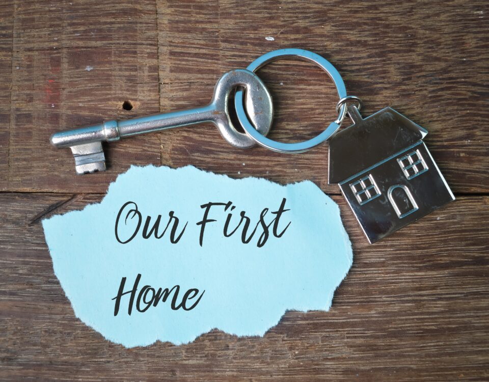 An image of a first home keyring with a house pendant on it on a table.