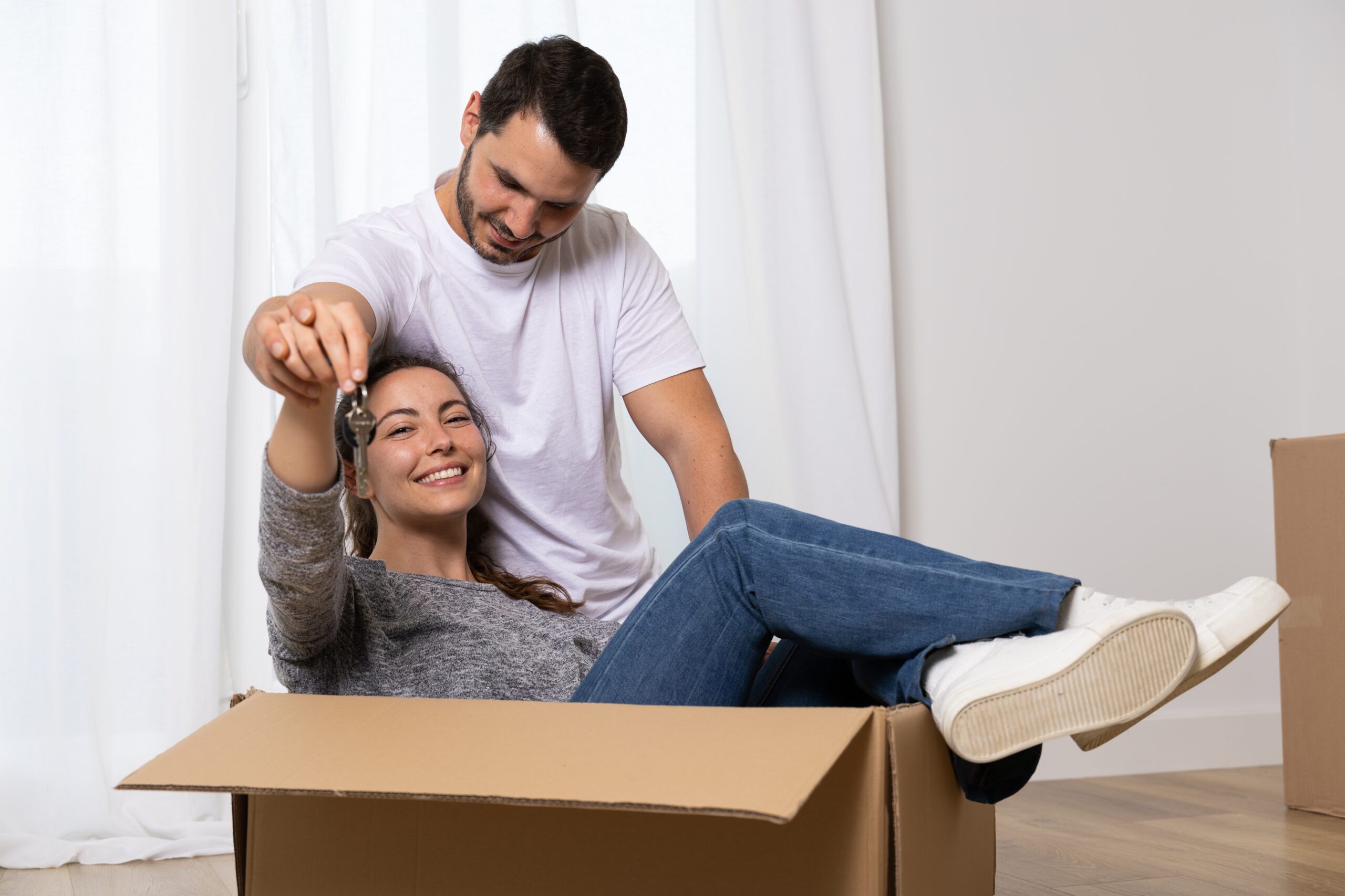 An image of a happy couple who have bought their first home together.