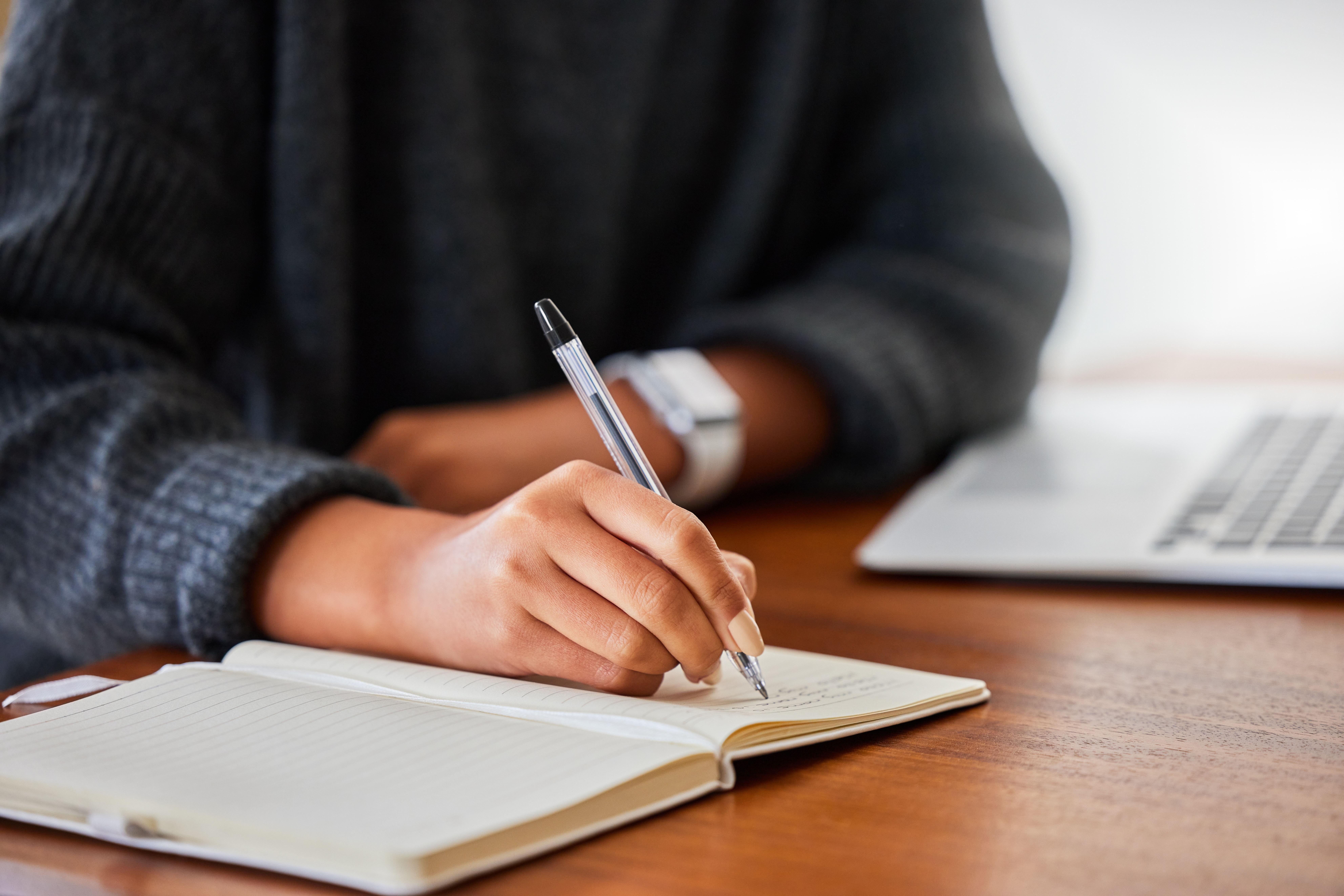 An image of someone writing up their small business plan in a notebook.