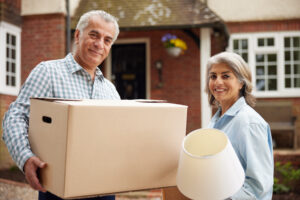 A couple packing their belongings and getting ready to downsize.