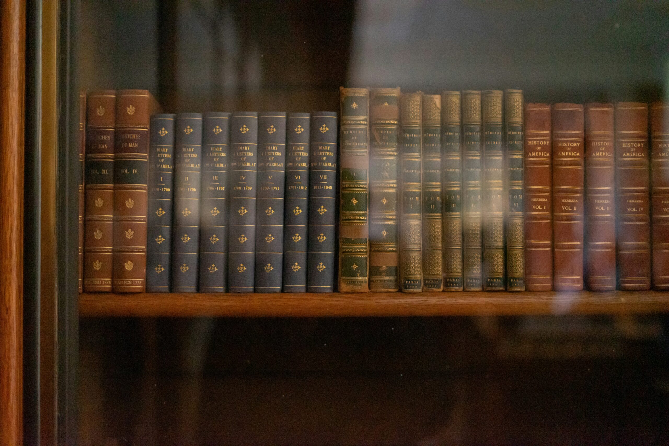 antique books stored in a book cabinet.
