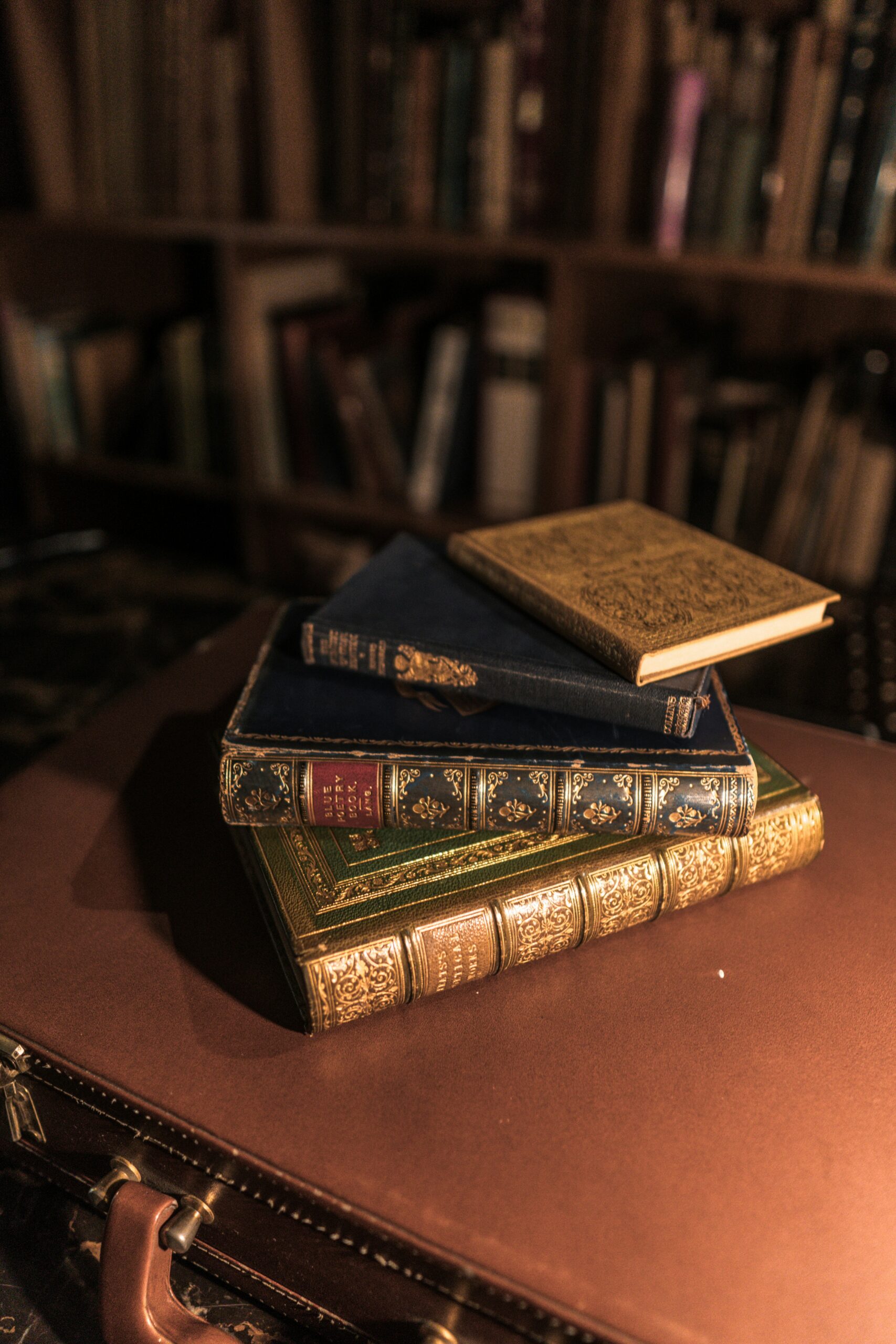 A stack of antique books on a table.