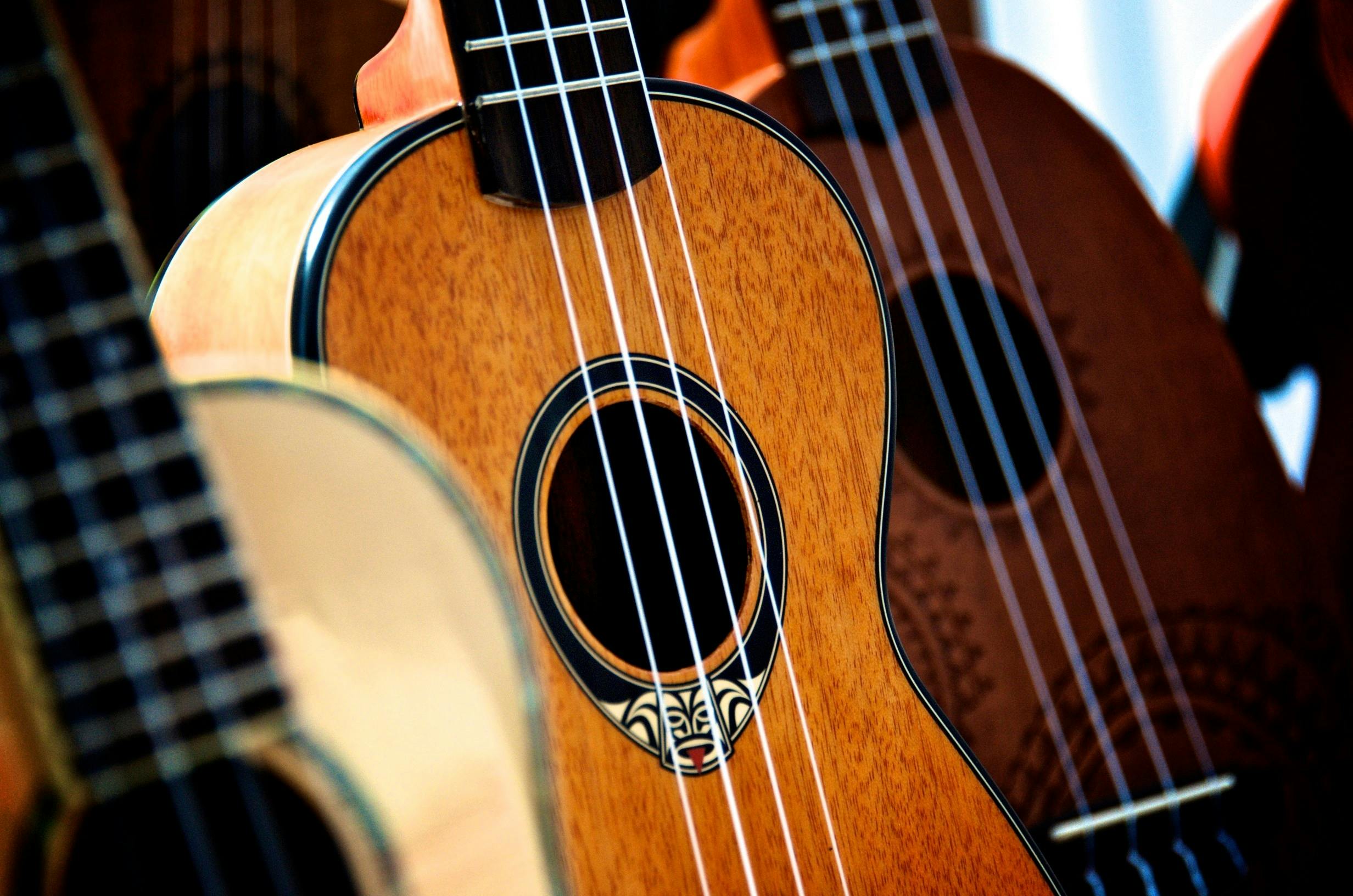 A close up of a collection of guitars.