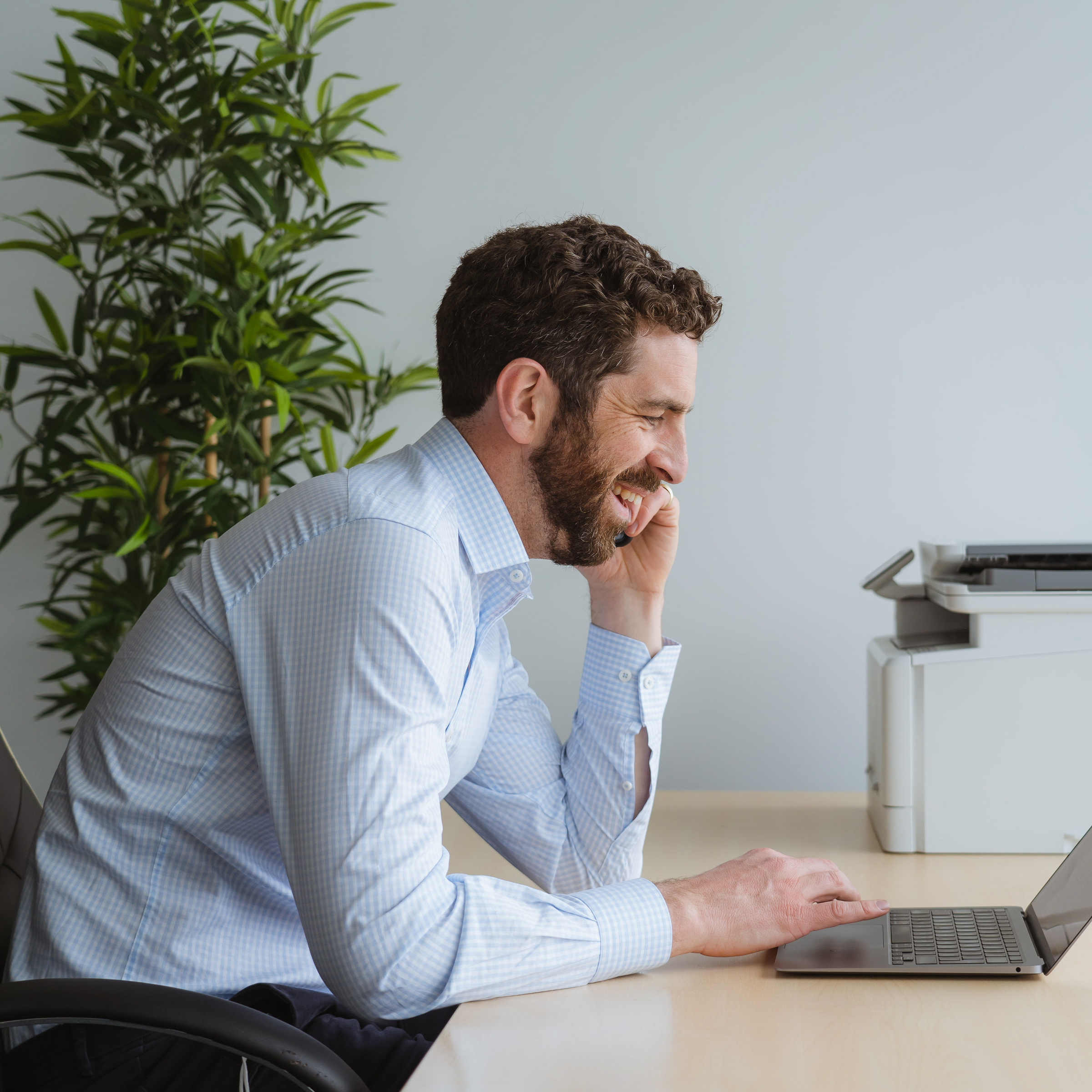 Business owner on the phone in office smiling